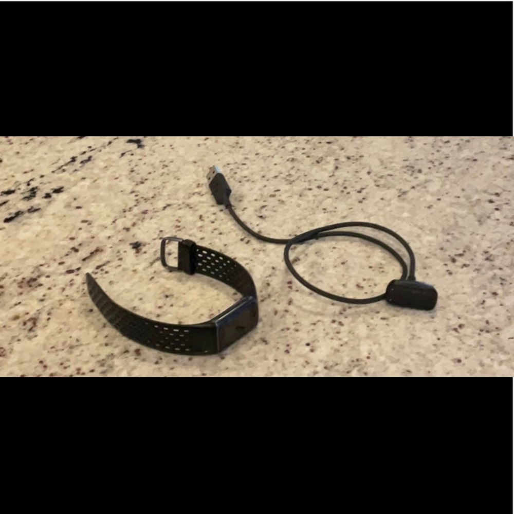 Fitbit charge 5 with charger.